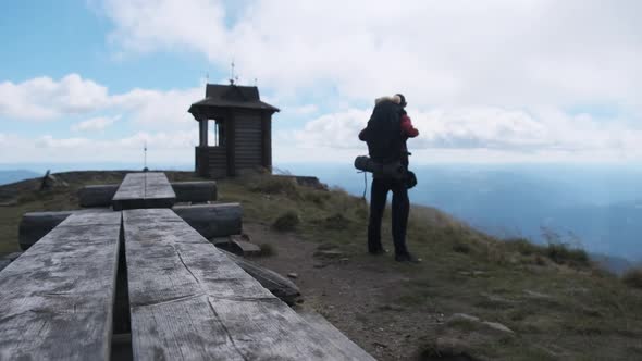 Tourist with Backpack on the Top of Mountain. Achievement of Goal