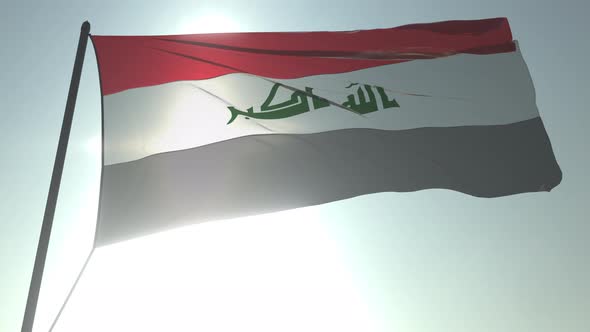 Waving Flag of Iraq Against Shining Sun and Sky