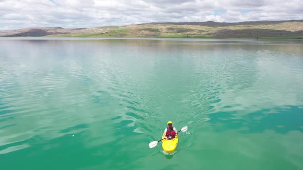 Young Man Canoeing On The Lake Aerial View