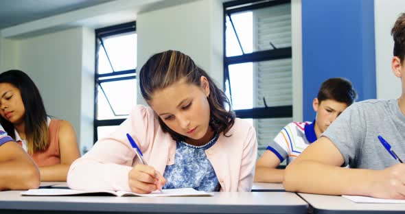 Schoolboy cheating during exam in classroom