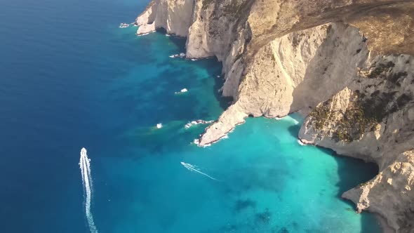 Aerial drone view of the Ionian Sea coast of Zakynthos, Greece. Rocky ridge, floating boats