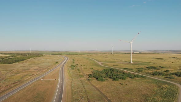 Aerial View of Wind Turbine on a Field in a Summer Day. Environment Friendly and Renewable Energy