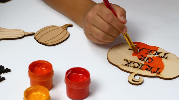 Halloween paints and decor. Children make Halloween decorations with their own hands.