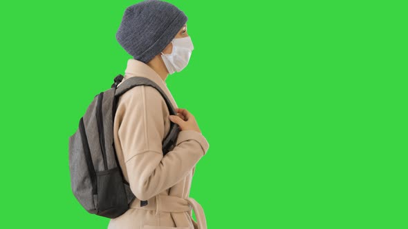 Covid-19 Virus Prevention, Woman Wearing a Medical Mask on Her Face Walking on a Green Screen