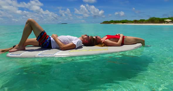 Happy boy and girl married on vacation enjoy life on beach on sunny white sandy background