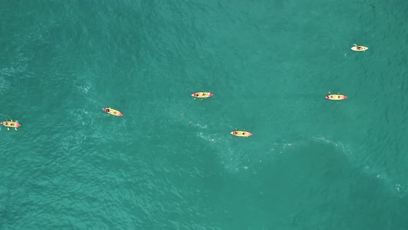 Drone Footage of Tourists Kayaking Within Turquoise Sea