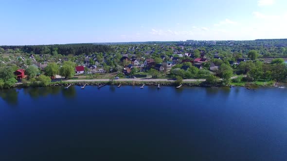 Small village with pond. Aerial view of rural landscape with small village near pond