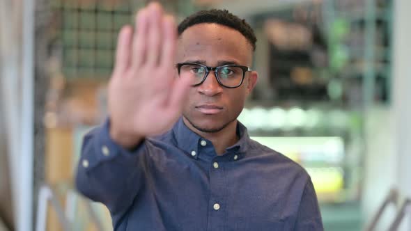 Serious African Man Showing Stop Sign By Hand