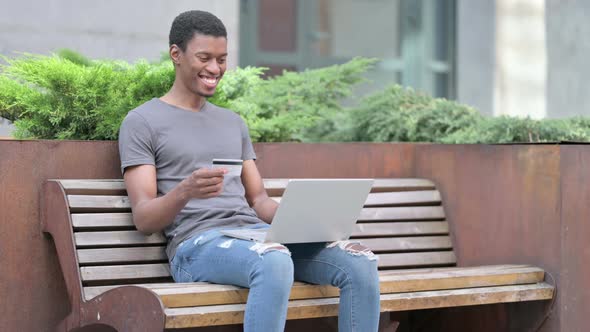 Successful Online Payment on Laptop By Young African Man