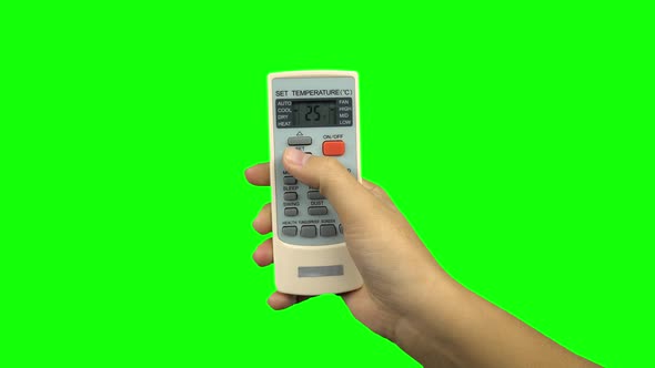 Hand Using a Remote Control To Change the Temperature of Air Conditioner. Green Screen