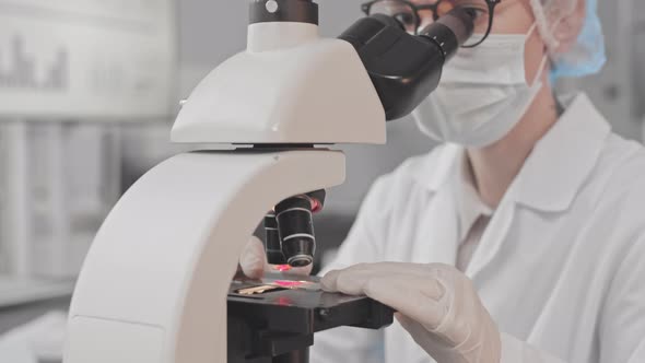 Female Scientist Using Microscope