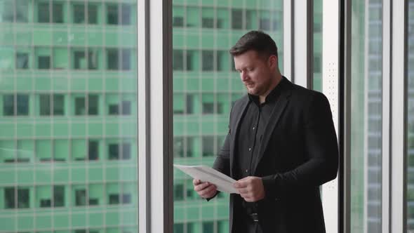 Businessman Standing Near the Window in the Office