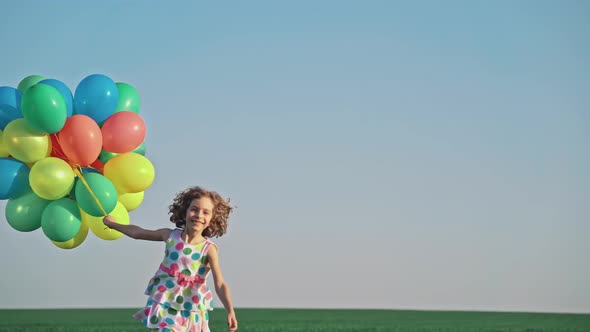 Happy Child Playing with Bright Multicolor Balloons  alt
