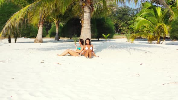 Tourists posing on beautiful bay beach time by shallow ocean and white sandy background of Thailand 