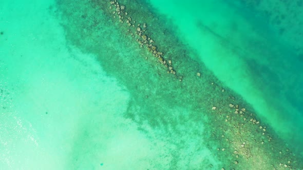 Beautiful drone copy space shot of a white paradise beach and aqua blue water background in colourfu