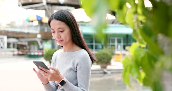 Woman use of mobile phone in the street