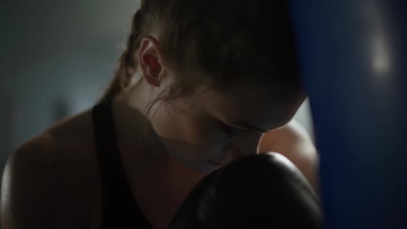 Woman Power Tired Female Fighter Trains His Punches Beats a Punching Bag Training Day in the Boxing