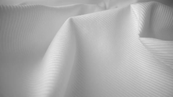 Shiny flowing cloth texture dolly shot in close up view macro shot.