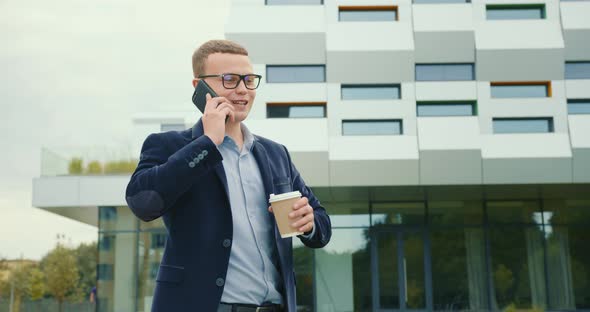 The Businessman Is Going and Talking Emotionally on the Phone