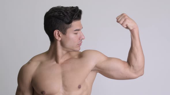 Young Handsome Muscular Shirtless Man Showing Biceps