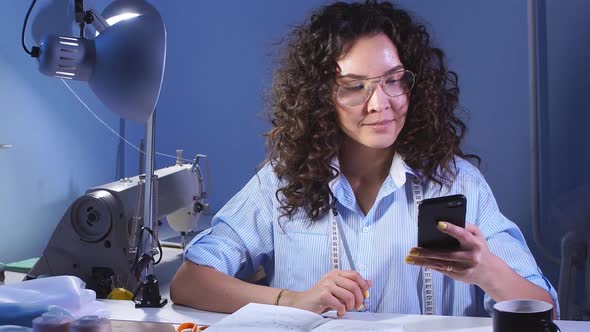 Young Creative Girl Designer Working at Home Studio in Evening. Sewing Business.