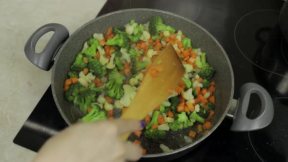 Mixing Fresh Vegetables on Frying Pan. Boiling Carrots, Cauliflower, Broccoli