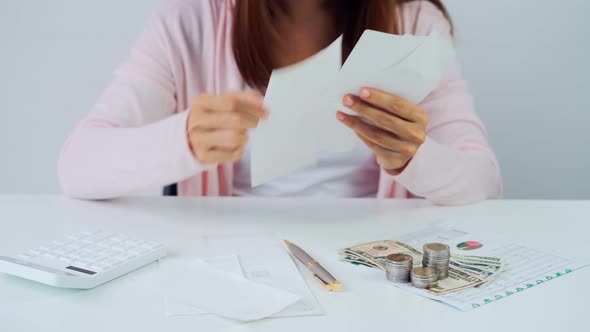 Stressed young woman calculating monthly home expenses