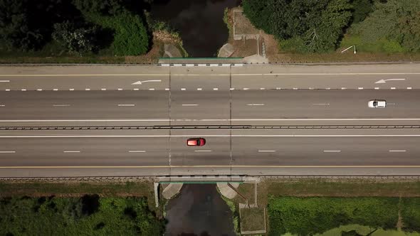 Top Down Close Up of Highway, White Arrow Signs Indicating Direction