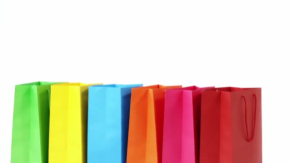 Multicolored shopping bags on white background