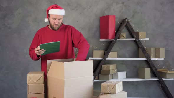 A Male Business Owner is Working Packing an Order to Be Sent to a Client