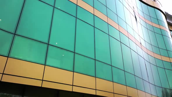 Modern design of a new greenand yellow architecture with glass mirror windows