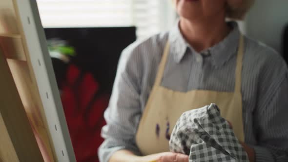 Tracking video of mature female artisan at home. Shot with RED helium camera in 8K.