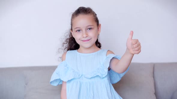 Funny Portrait Little Girl Smiling Child Looking at Camera Sit on the Couch at Home, Cute Kid Child