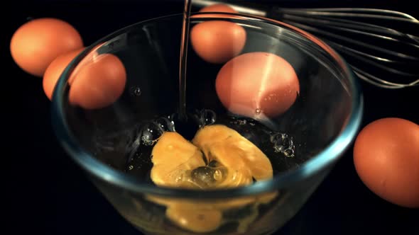 Super Slow Motion Raw Egg Falls Into the Bowl with Splashes