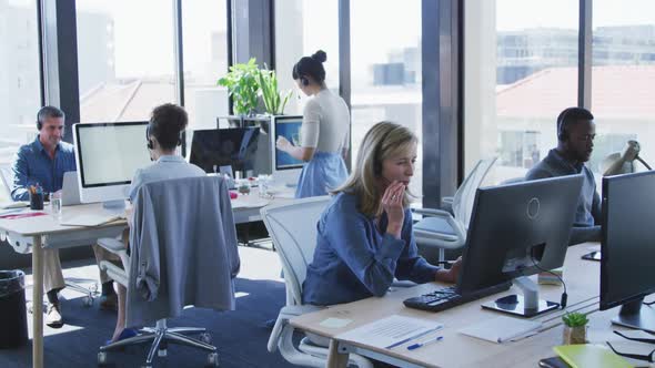 People with headset working on computer