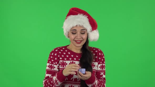 Portrait Girl in Santa Claus Hat Is Opening Small Box with Surprise and Is Disappointed