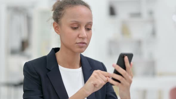 Portrait of Attractive African Businesswoman Using Smartphone 