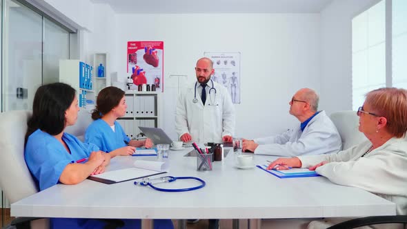 Doctor Having Professional Discussion with Medical Staff