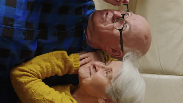 Relaxed Loving Married Elderly Man and Woman Hugging and Looking Away Wife Resting on Her Husband's