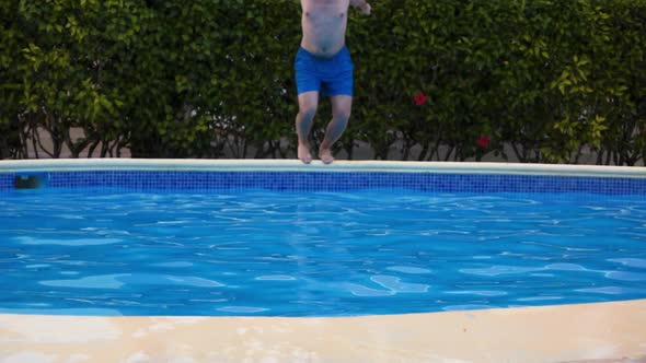 Man Jump Into Swimming Pool at Tropical Island Hotel