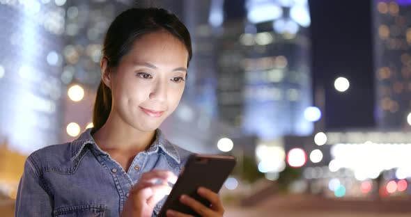 Young woman use of mobile phone in city