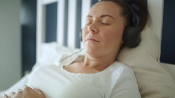 Close up video of woman pregnant listening to music. Shot with RED helium camera in 8K  