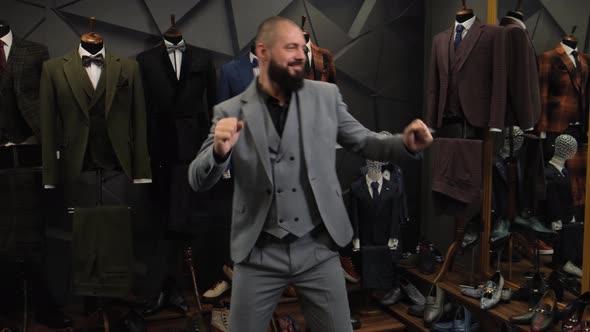 Happy and Confident Man Dancing in a Taoilor Shop. Millennial Businessman with Classic Suit Perform