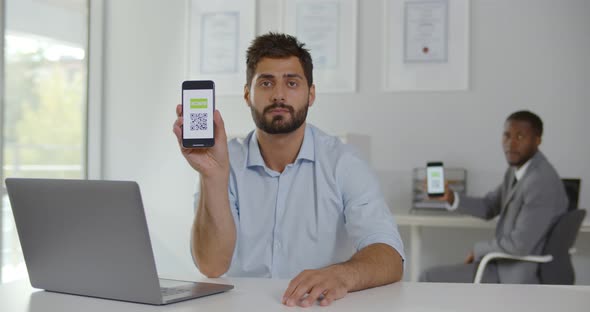 Diverse Office Workers Smiling at Camera Showing Smartphone with Vaccinated Qrcode