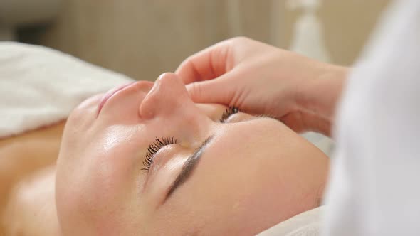 Facial Massage Performed By Professional Beautician in Beauty Clinic