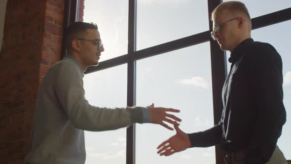 Coworkers Greeting In Office