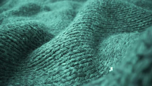 Extreme detail view of sheep wool cloth texture flowing in macro dolly shot.