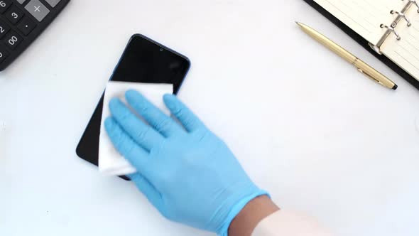 Cleaning Mobile Phone Display on Table