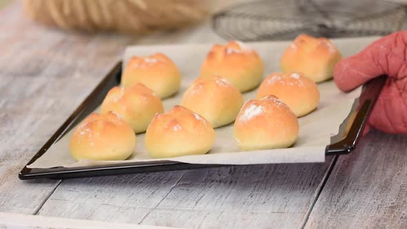 Delicious Freshly Baked Yeast Buns with Crust on Baking Sheet.