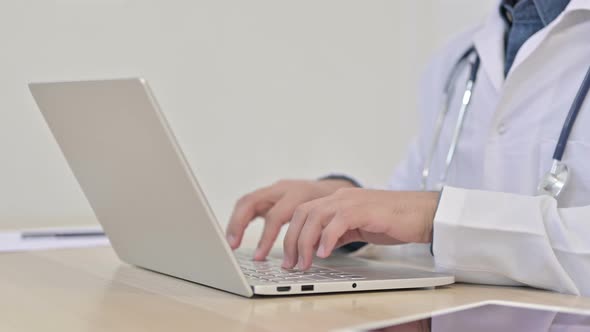 Close Up of Doctor Typing on Laptop 